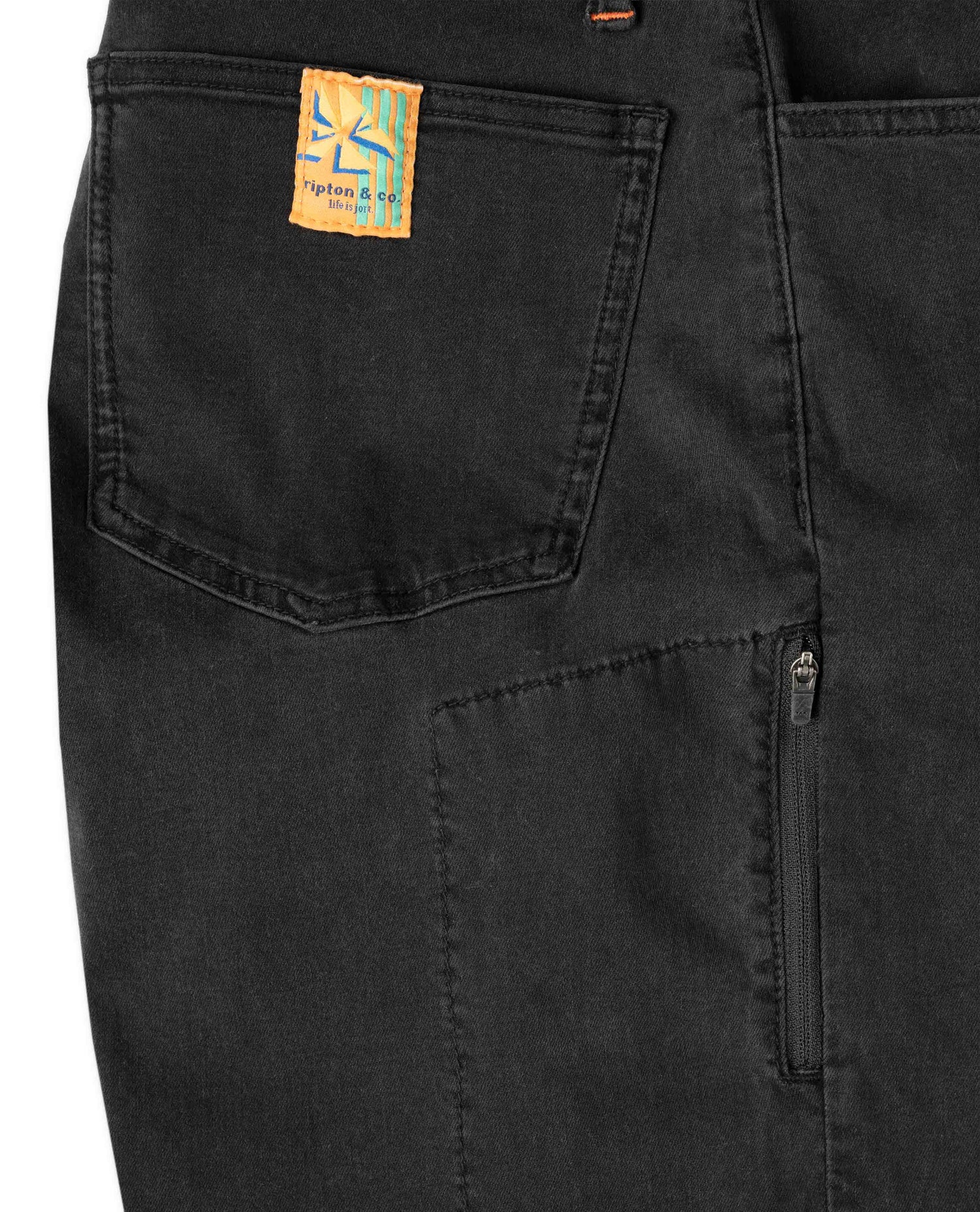 Black pants with a brand label on the pocket against a white background