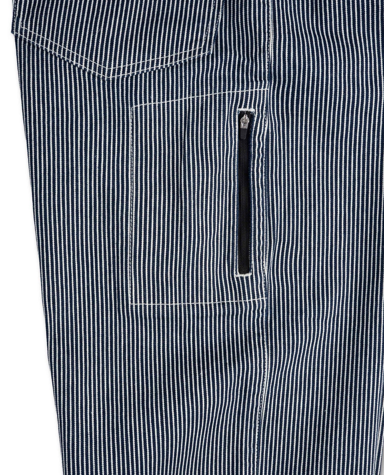 Close-up of a black and white striped garment with a zipper pocket.