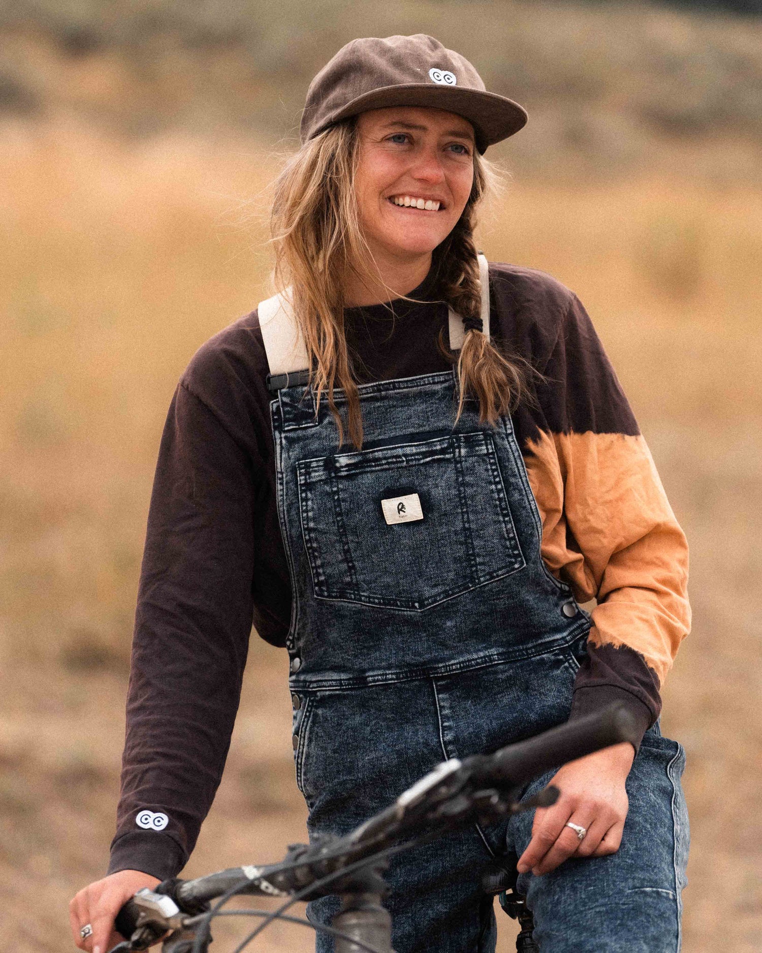 Woman wearing Indigo Marble denim overalls