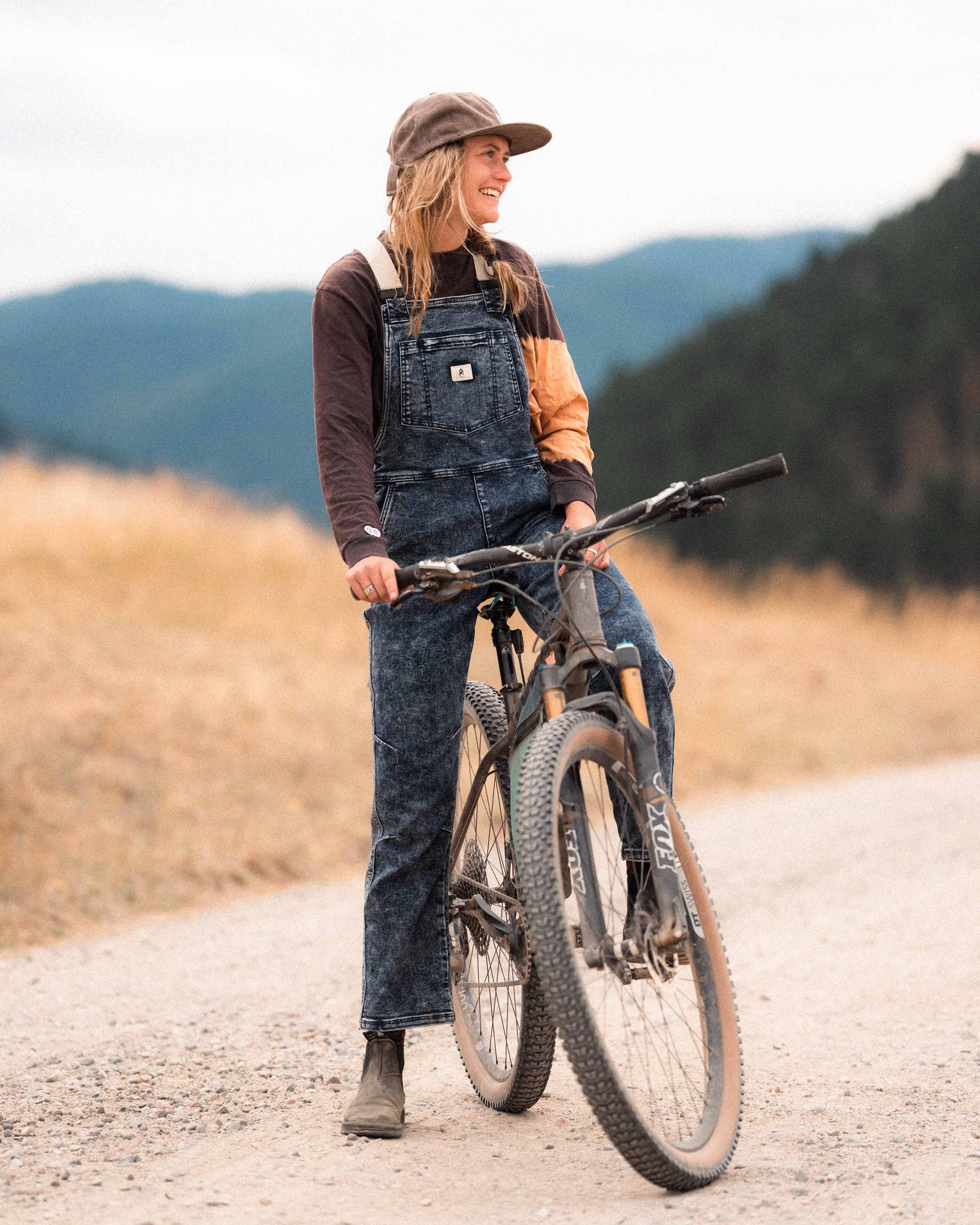 Woman wearing Indigo Marble denim overalls