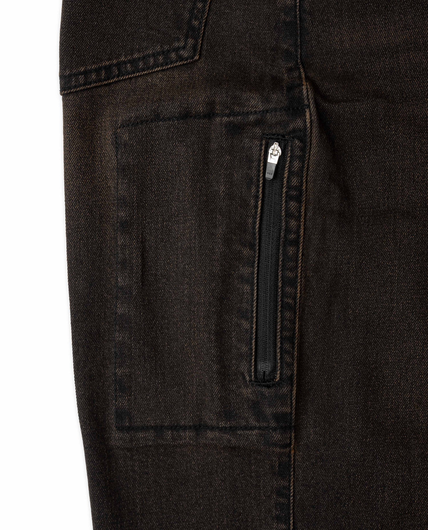 Close-up of dark jeans with a zipper pocket on a white background