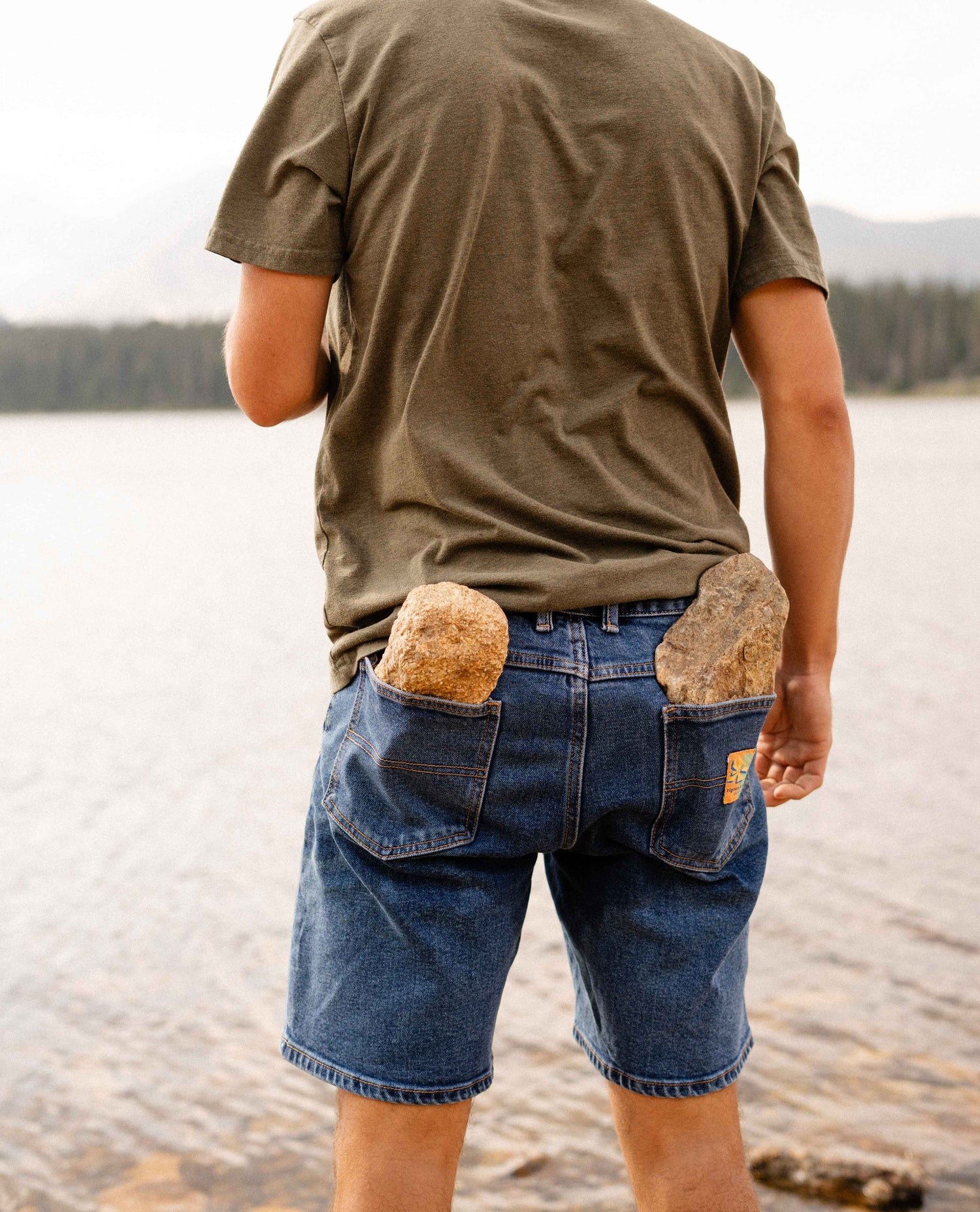 Man in Ripton DTJ jorts with large rocks in his pockets. 