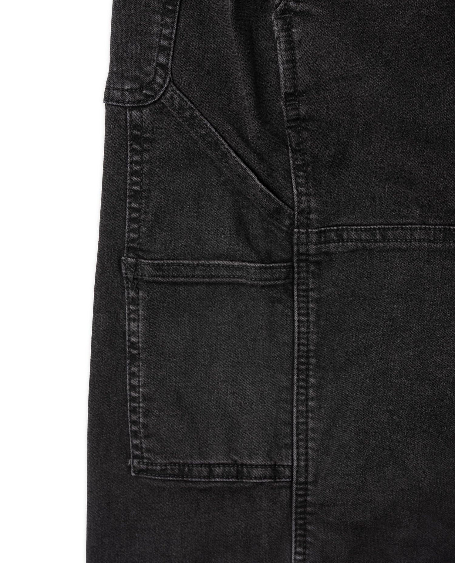 Close-up of a black denim jacket with pocket details on a white background