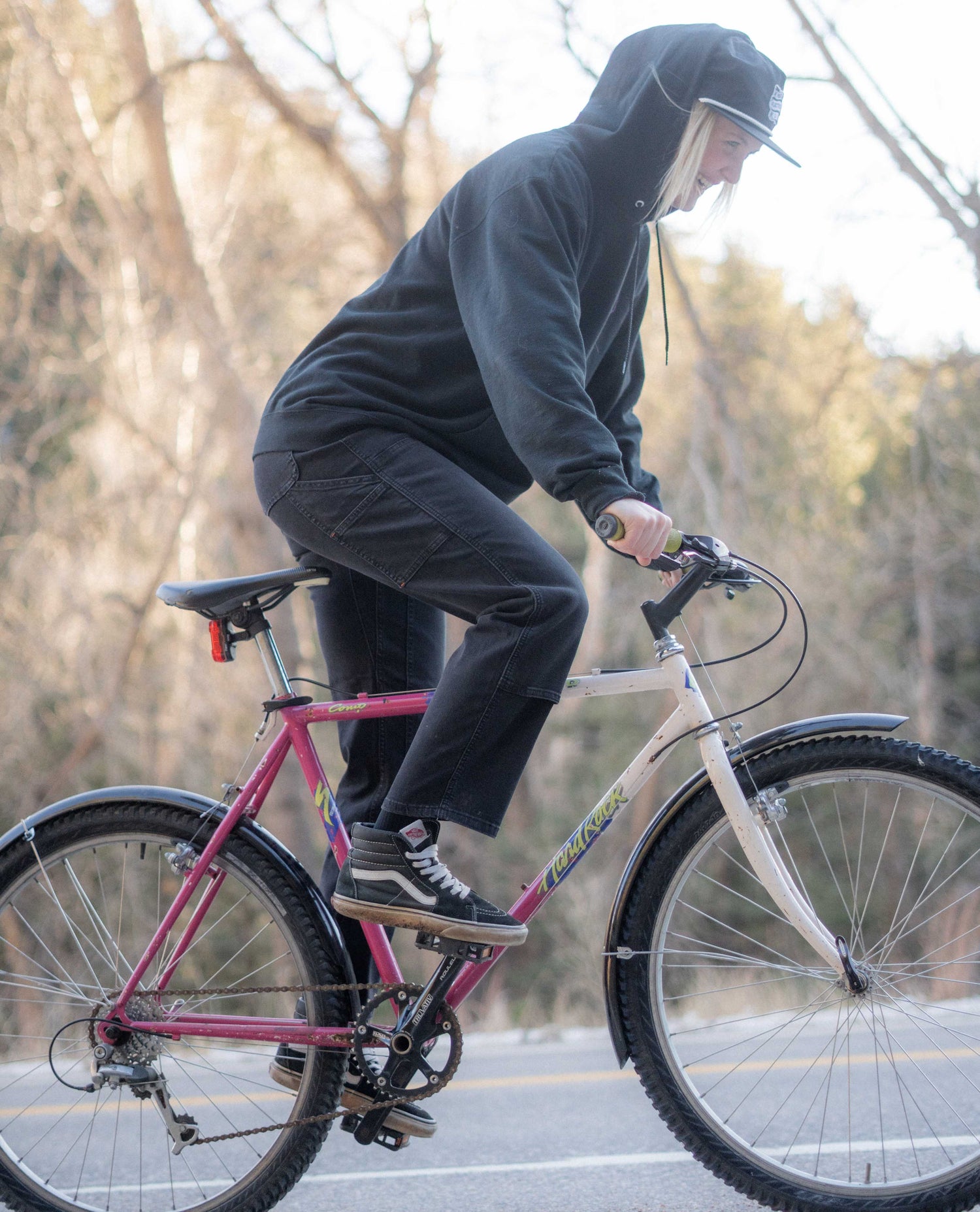 Mo riding a bike with a hoody