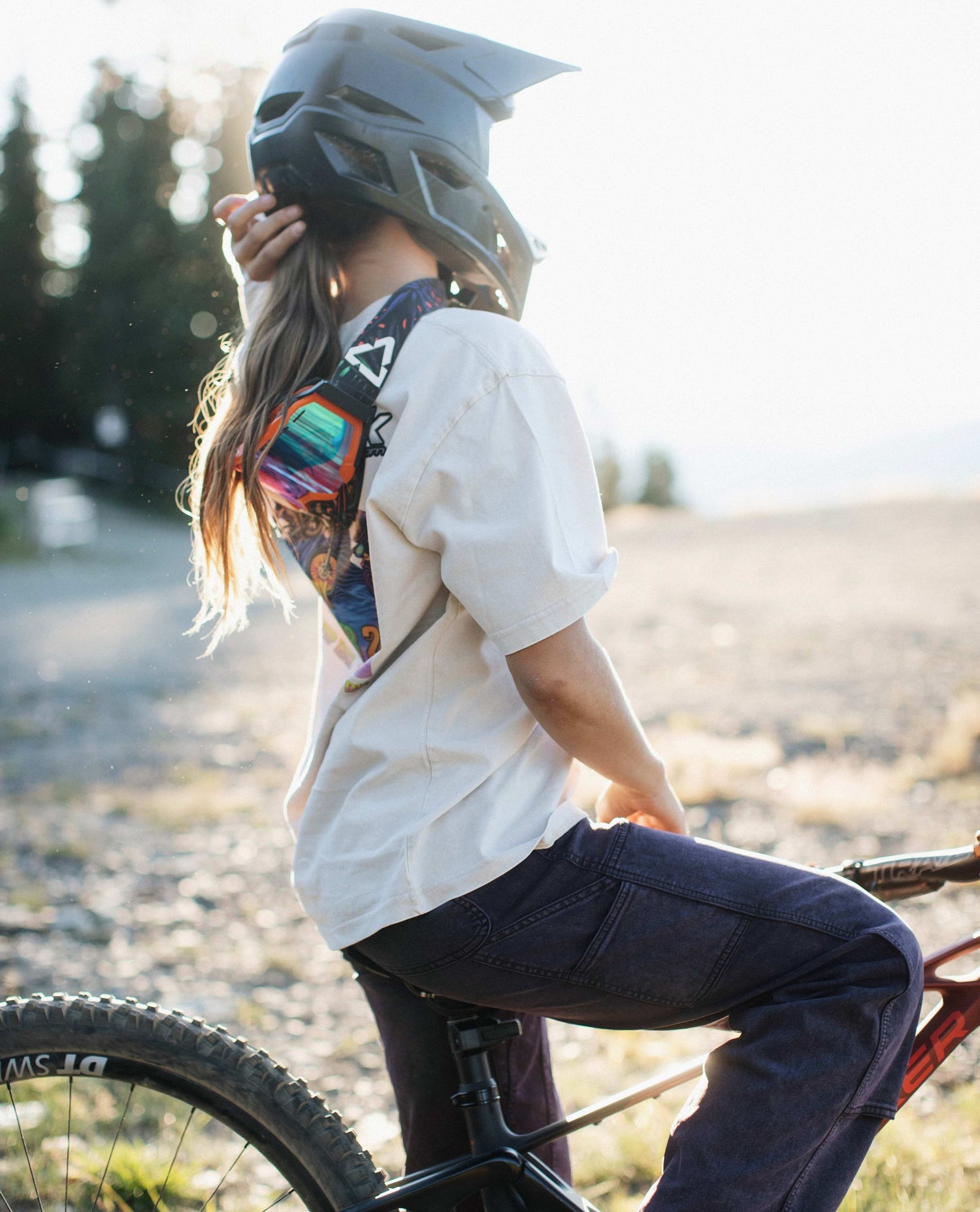 Person sitting on a bike wearing a helmet in an outdoor setting