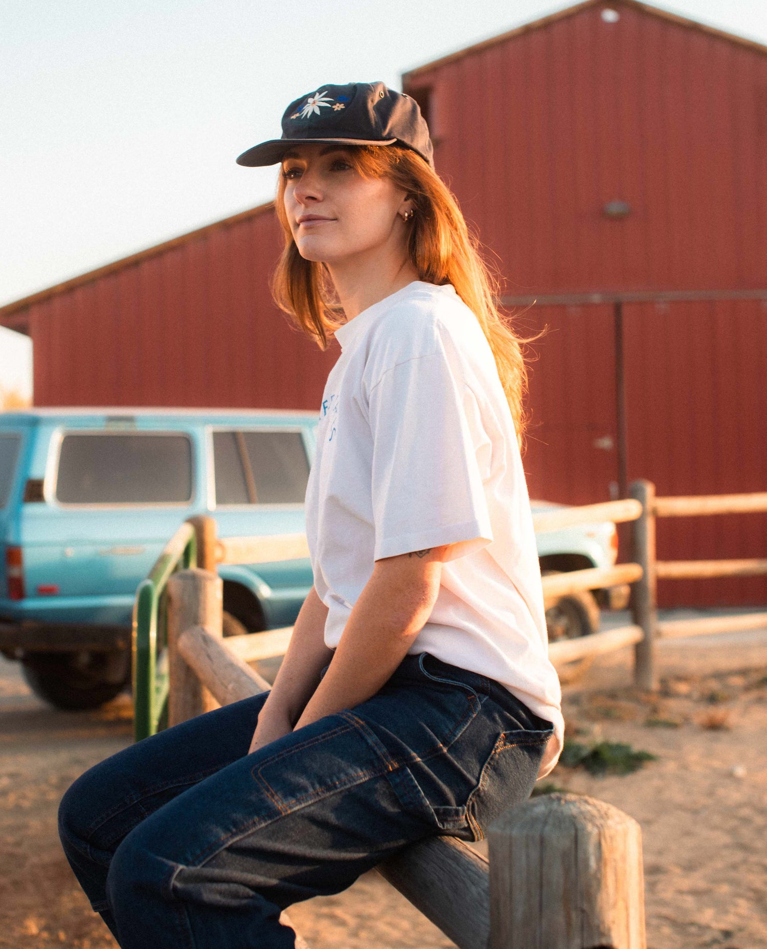 Woman sitting in Blue Collar Sport Utility Jeans. 