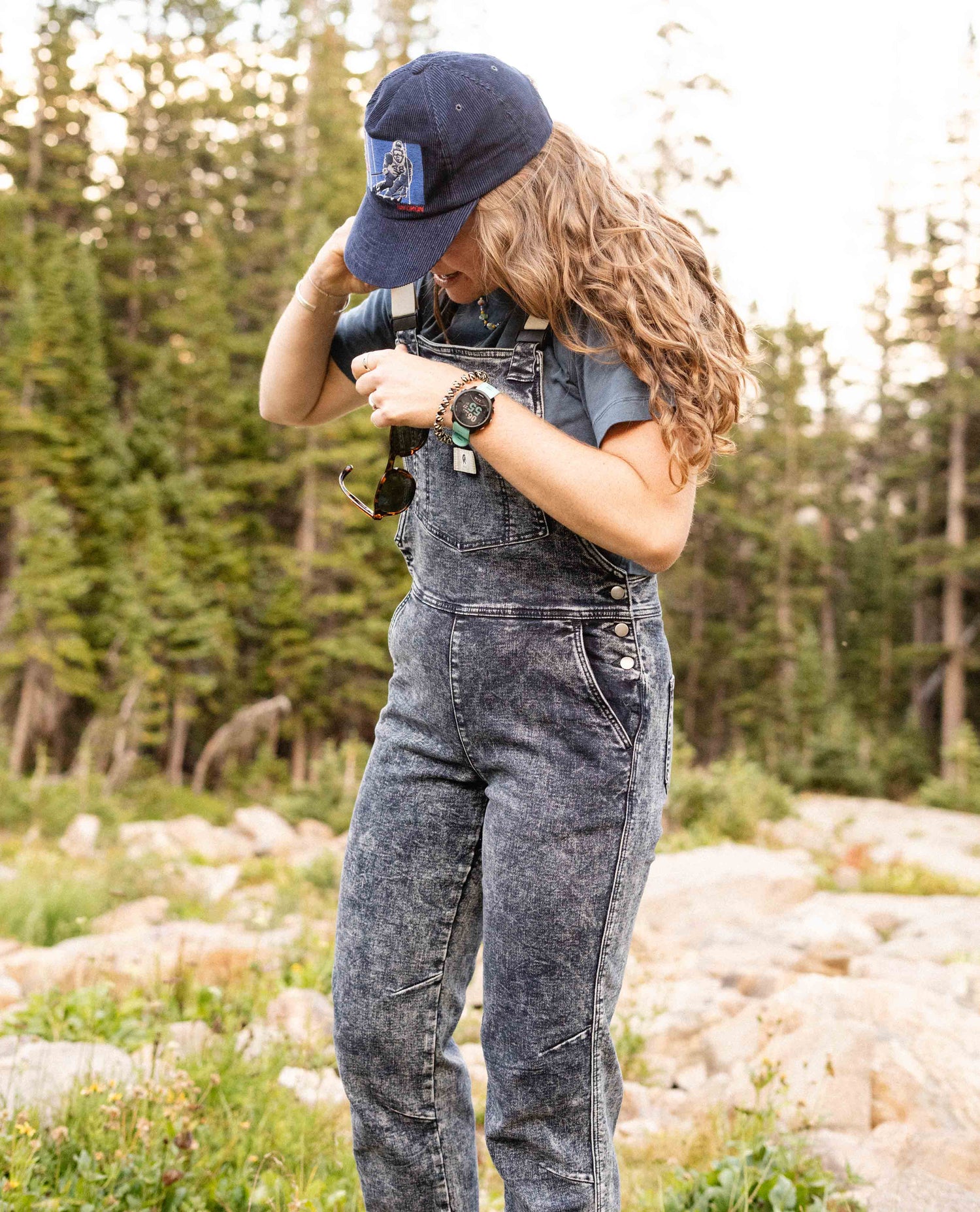 Woman wearing Indigo Marble denim overalls