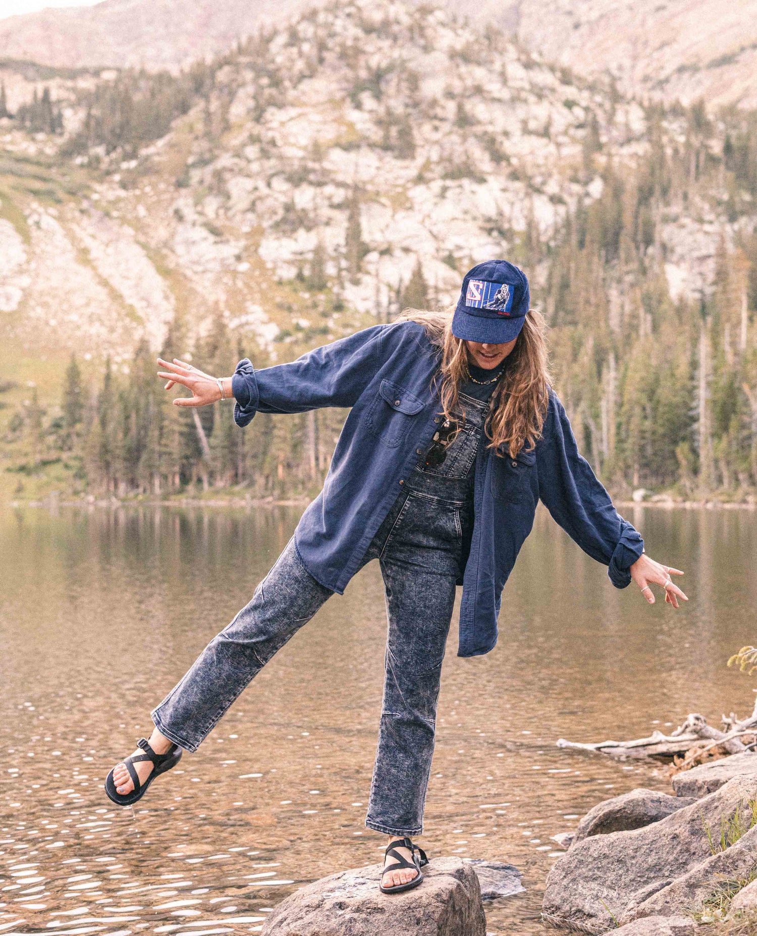 Woman wearing Indigo Marble denim overalls