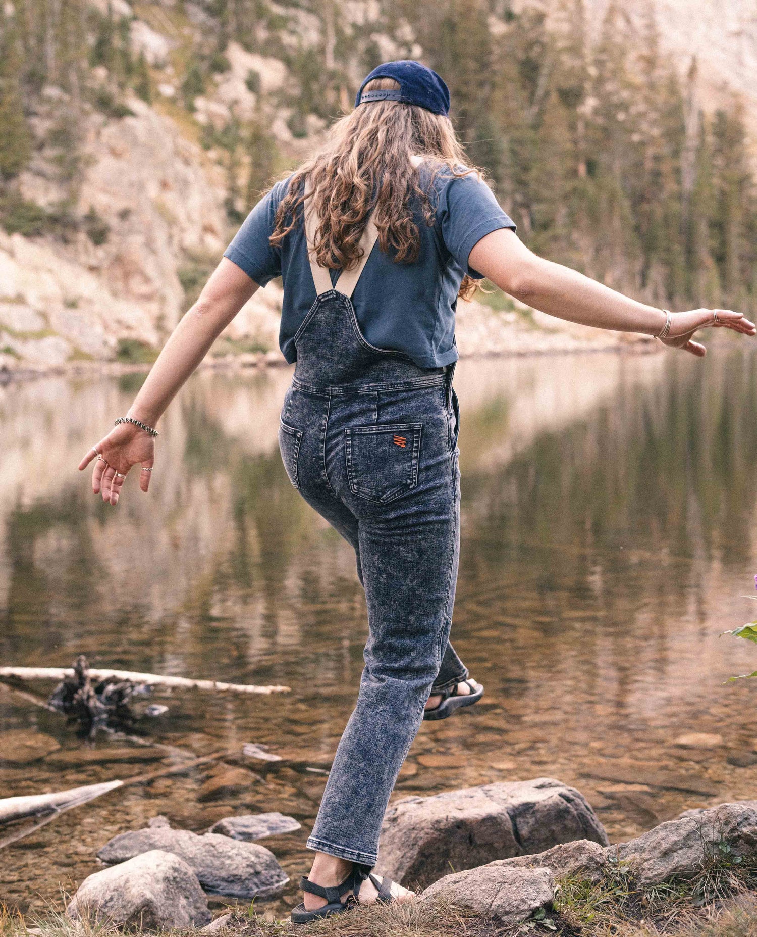 Woman wearing Indigo Marble denim overalls