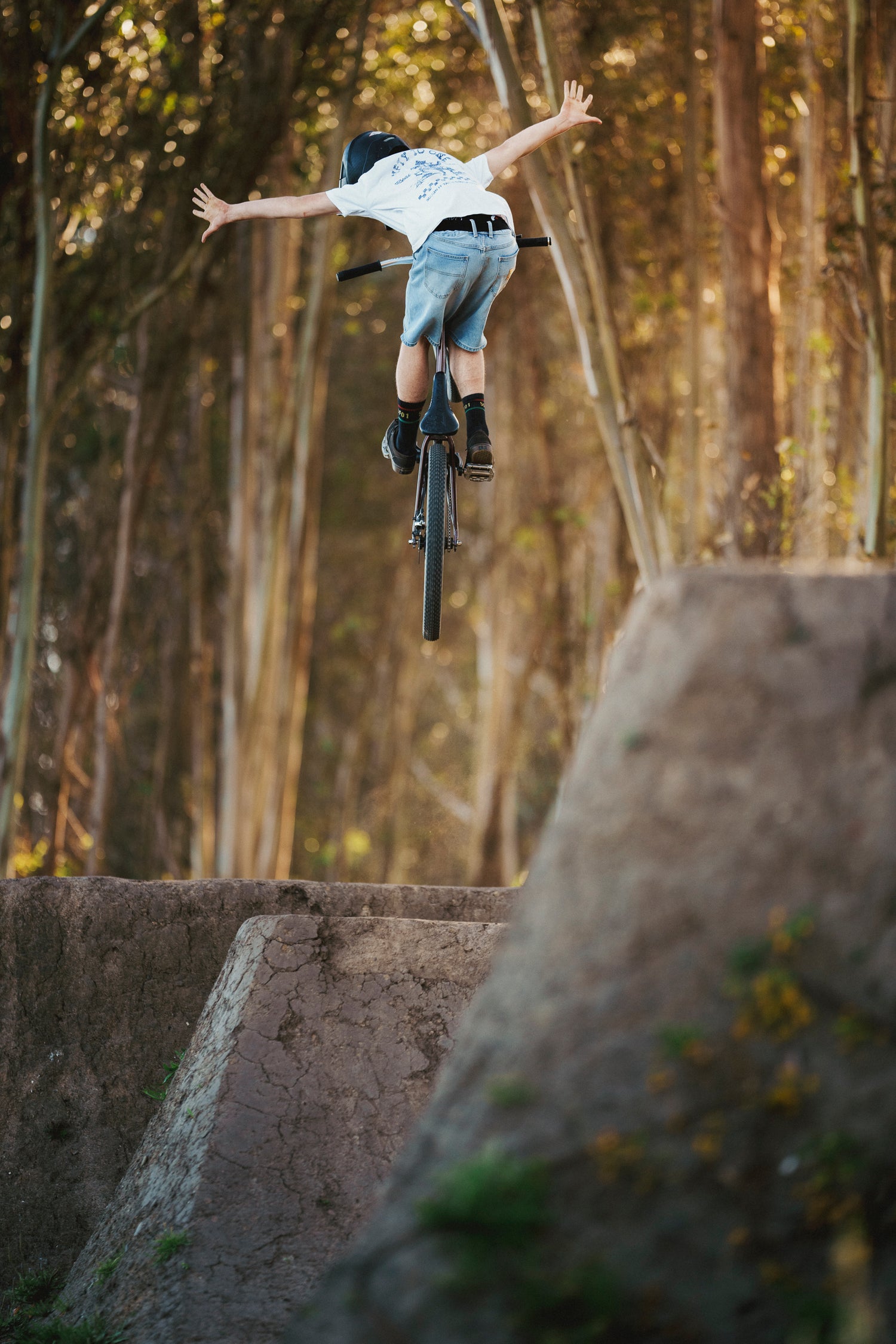 Man in Ripton jean shorts jumping his bike