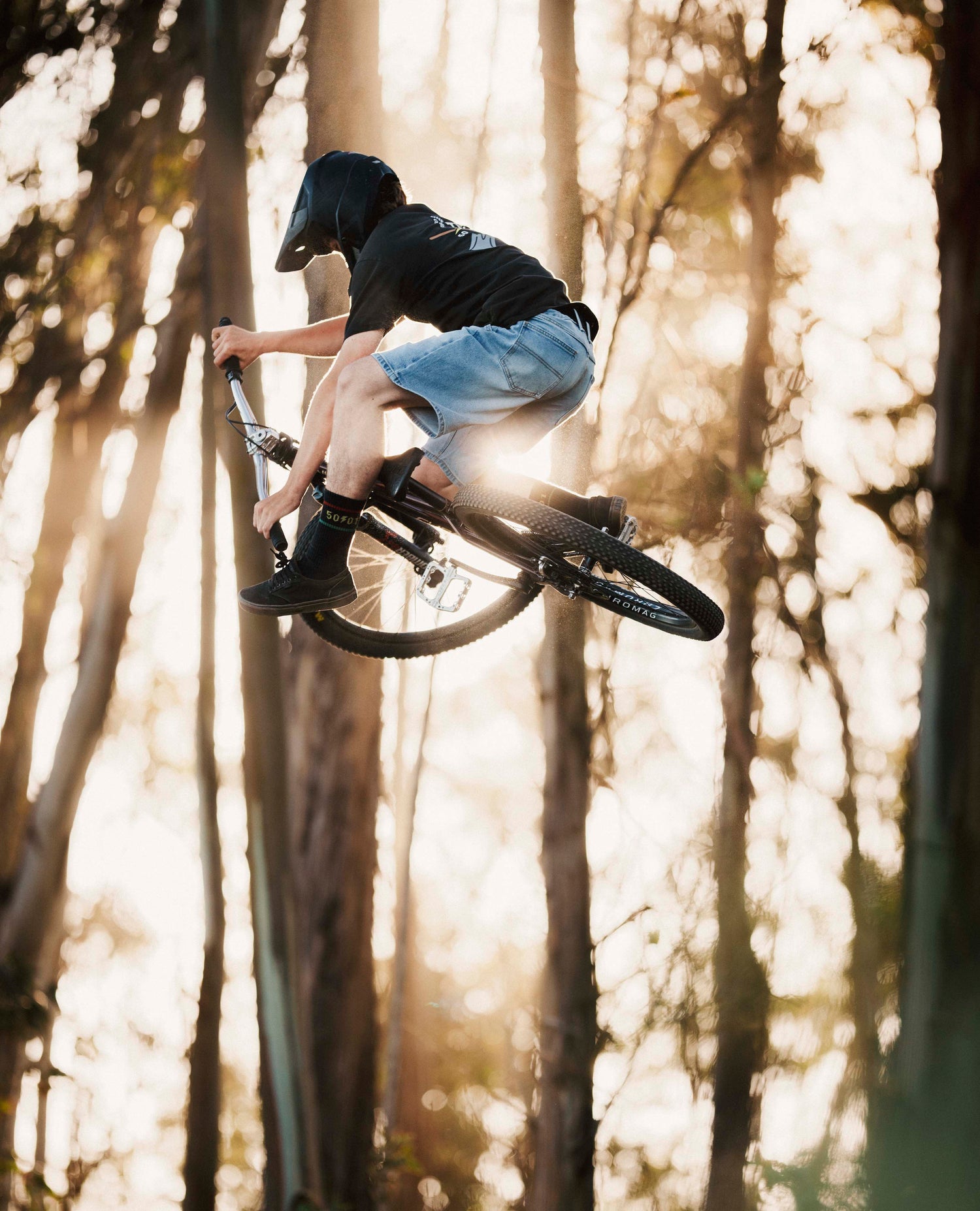 Man in Ripton jean shorts jumping his bike