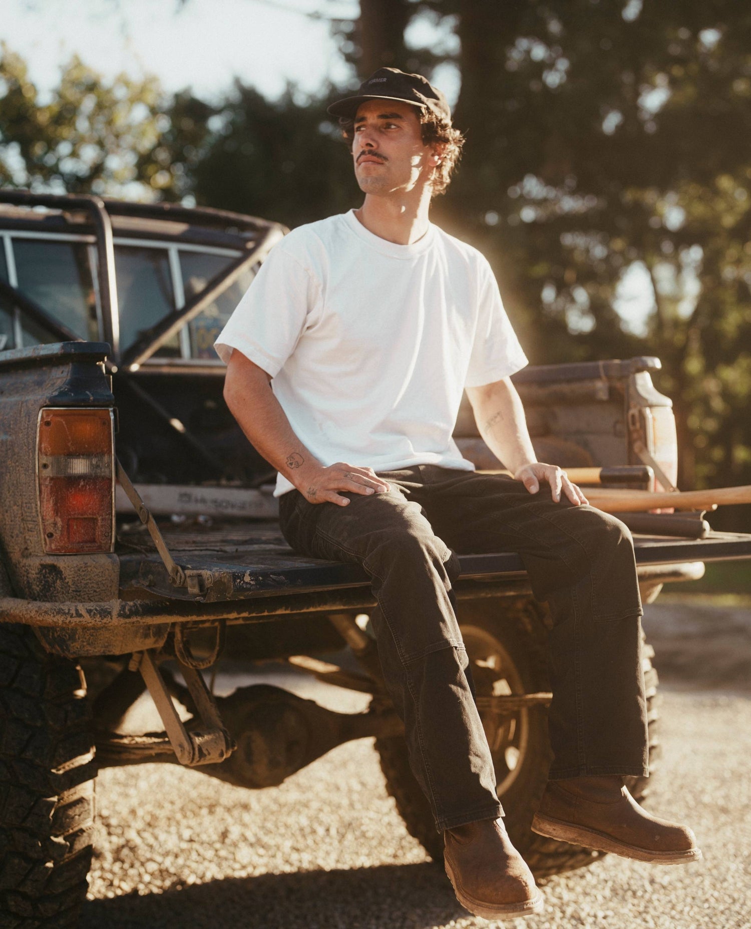 Isaac sitting on his truck's tailgate