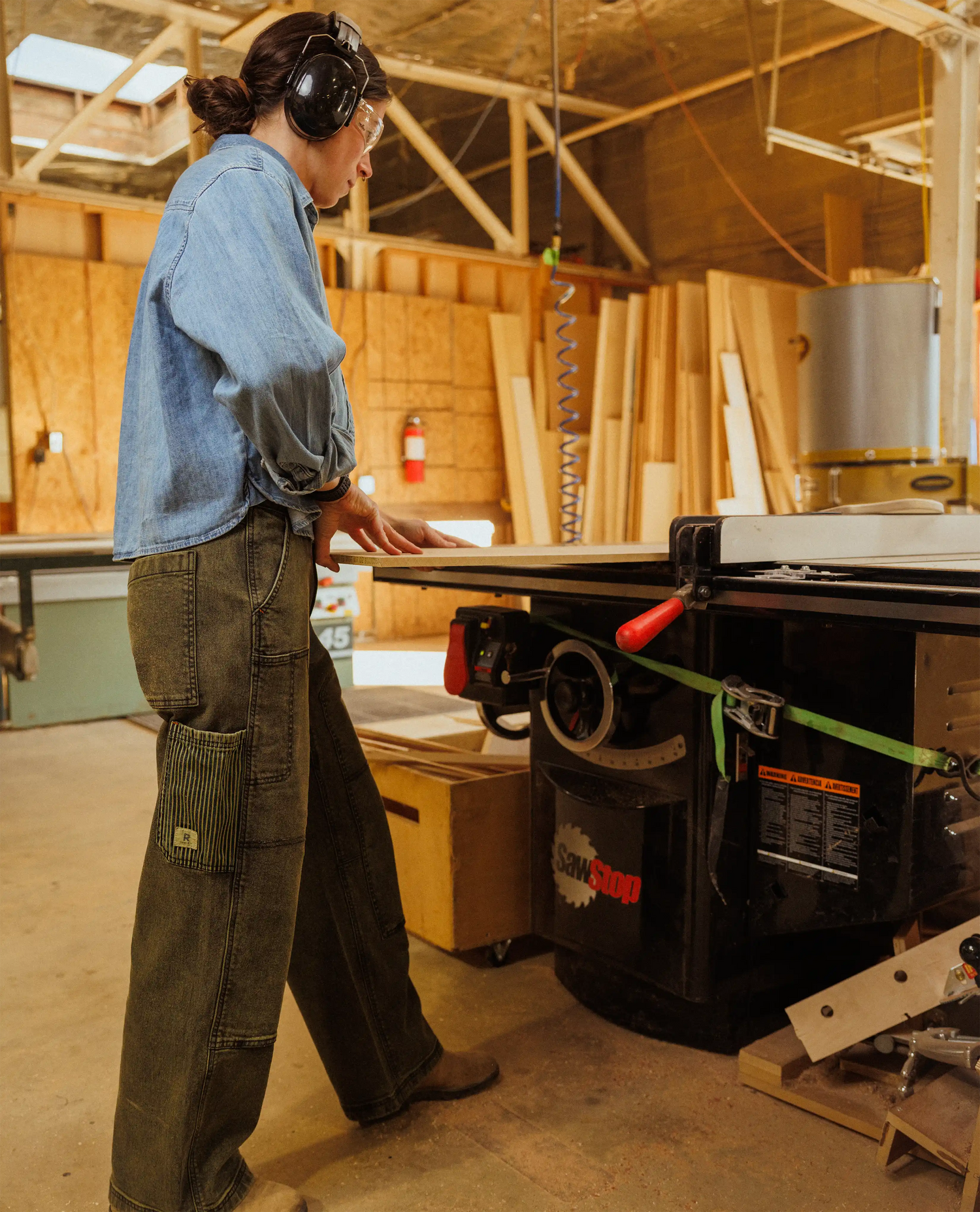 Person operating a table saw in a workshop