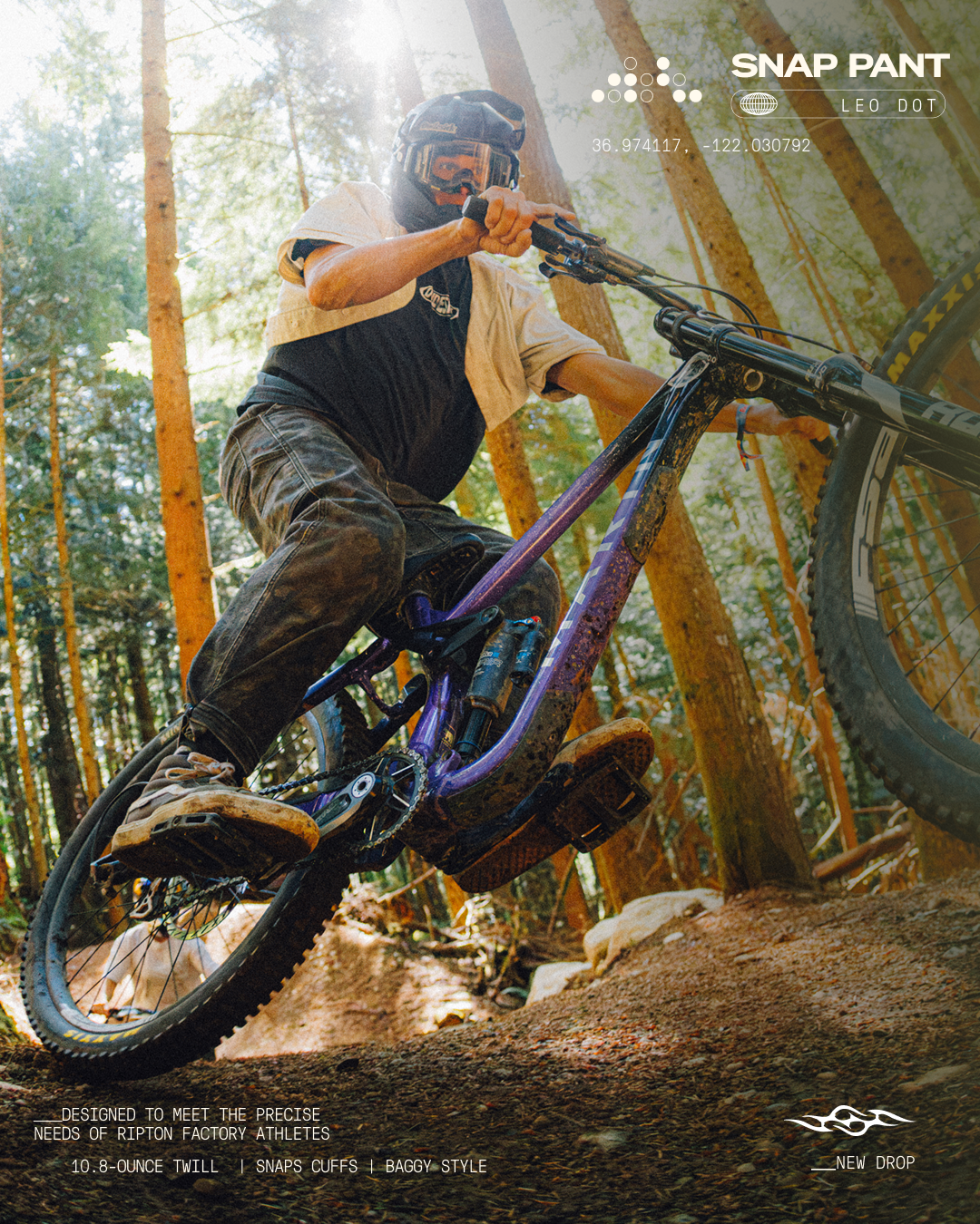 A mountain biker in a forest wearing a black and white Snap Pant hoodie and dark pants, riding a purple and black full-suspension bike over a dirt trail. The image features the Snap Pant brand logo and text overlays.