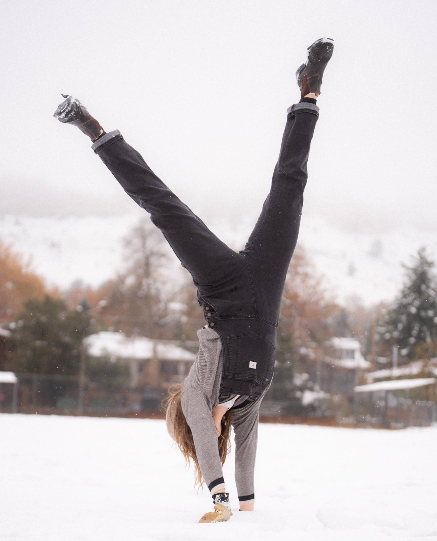 Sofia doing a cartwheel in overalls