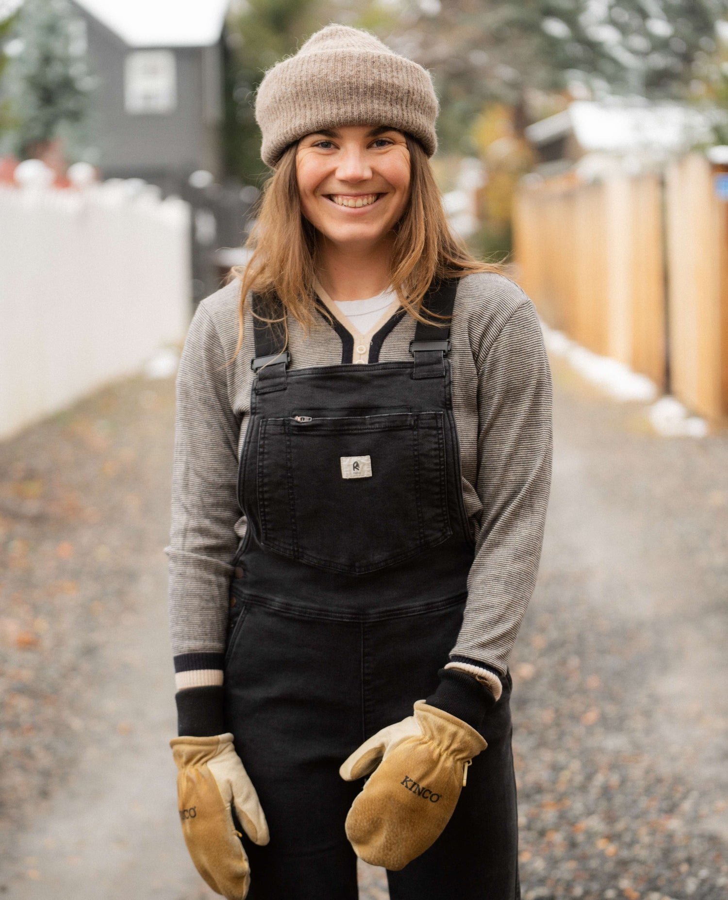 Sofia in an alley wearing overalls