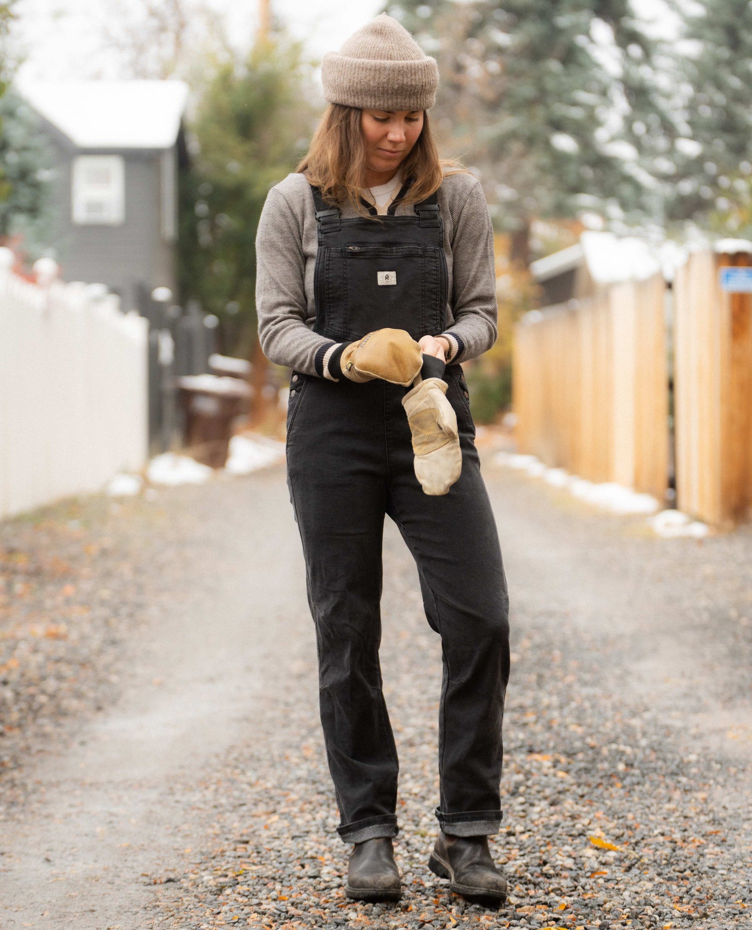 Sofia in an alley wearing overalls