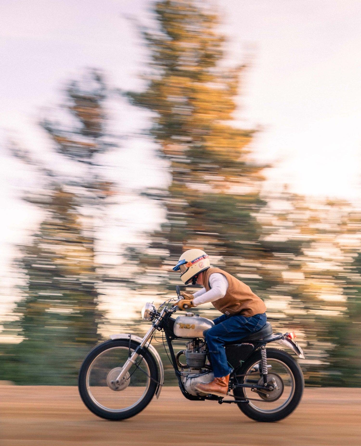 guy riding a motorcycle in jeans