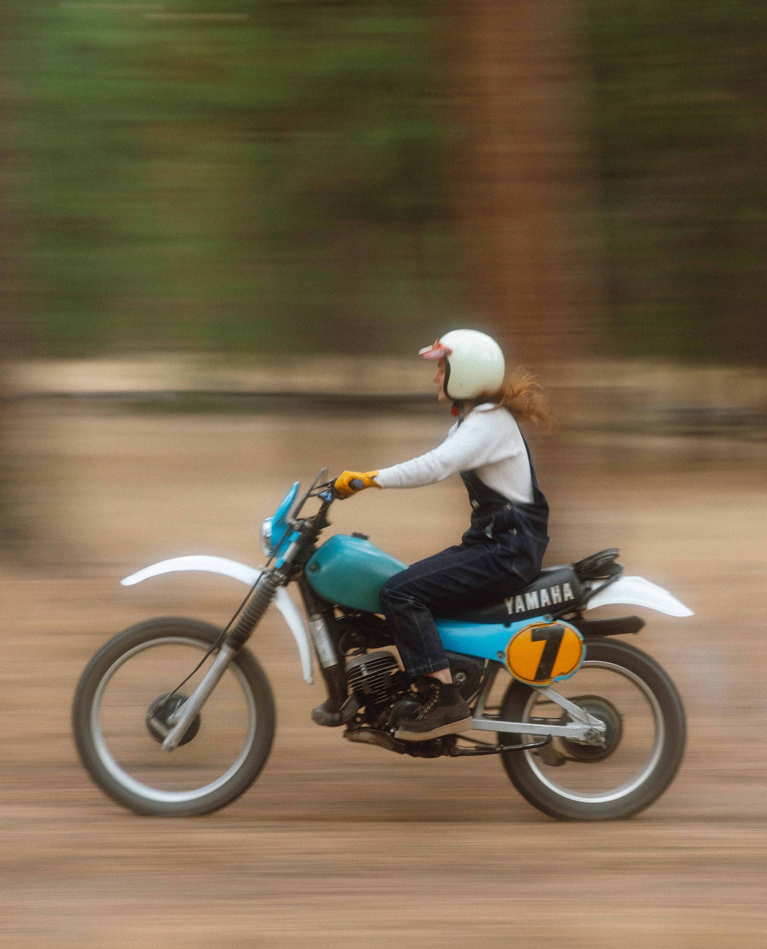 Alex wearing Starving Jartist Overalls on a dirt bike