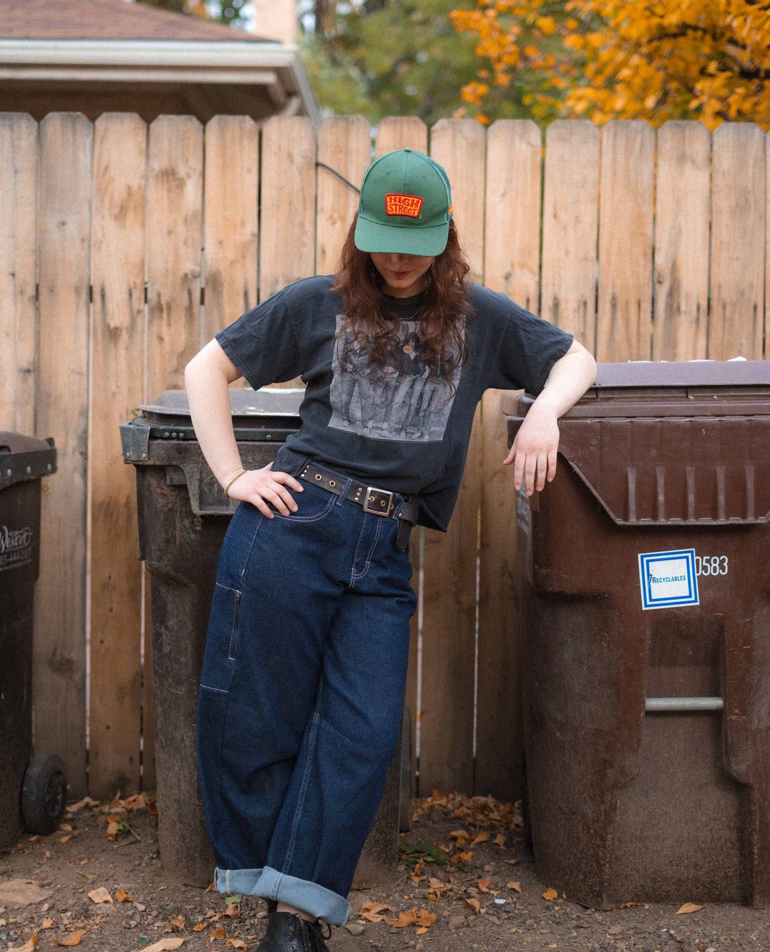 Woman leaning on a trash bin in her tuxedo Ripton Jantalones. 