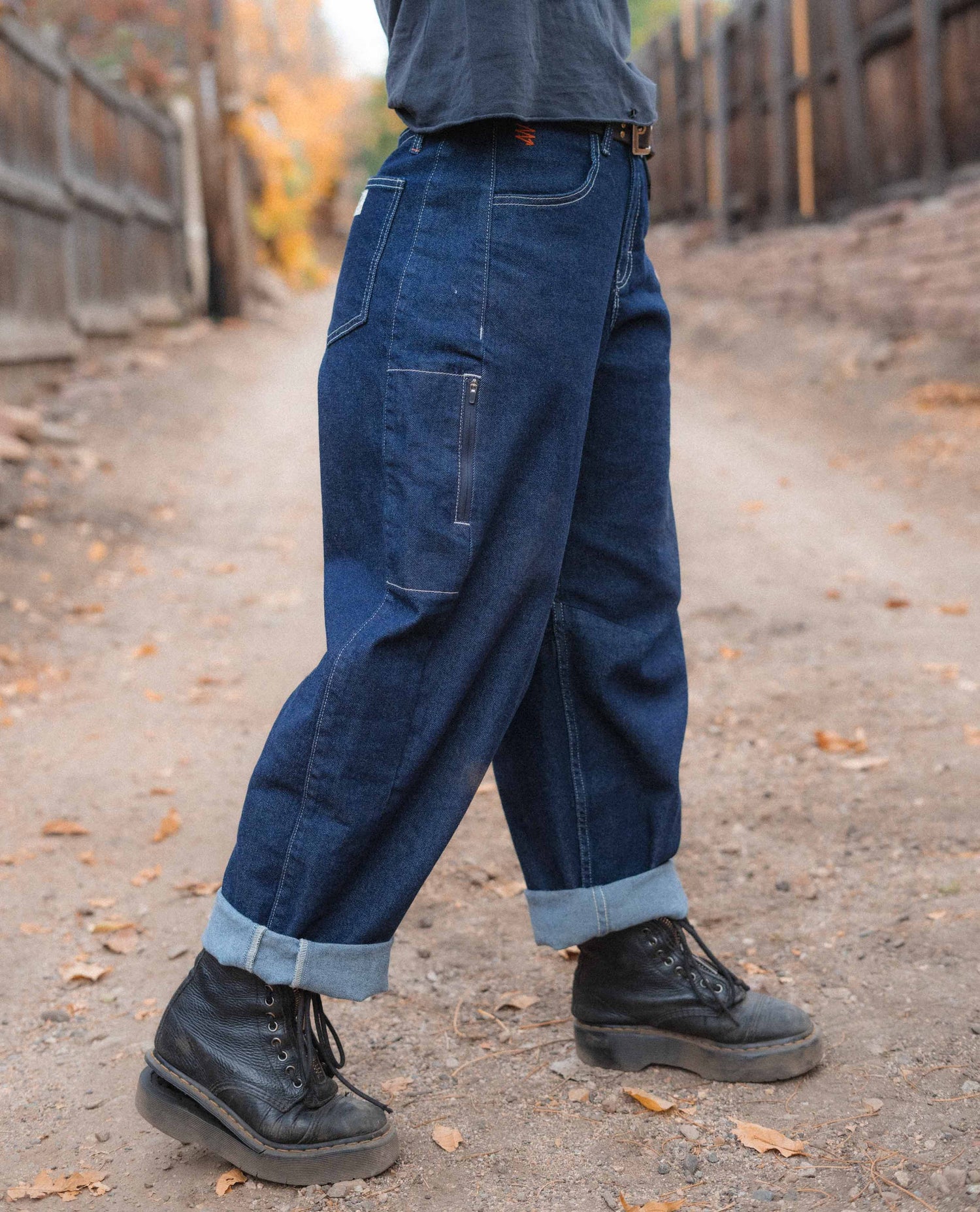 Woman standing in an alleyway in her tuxedo Ripton Jantalones. 