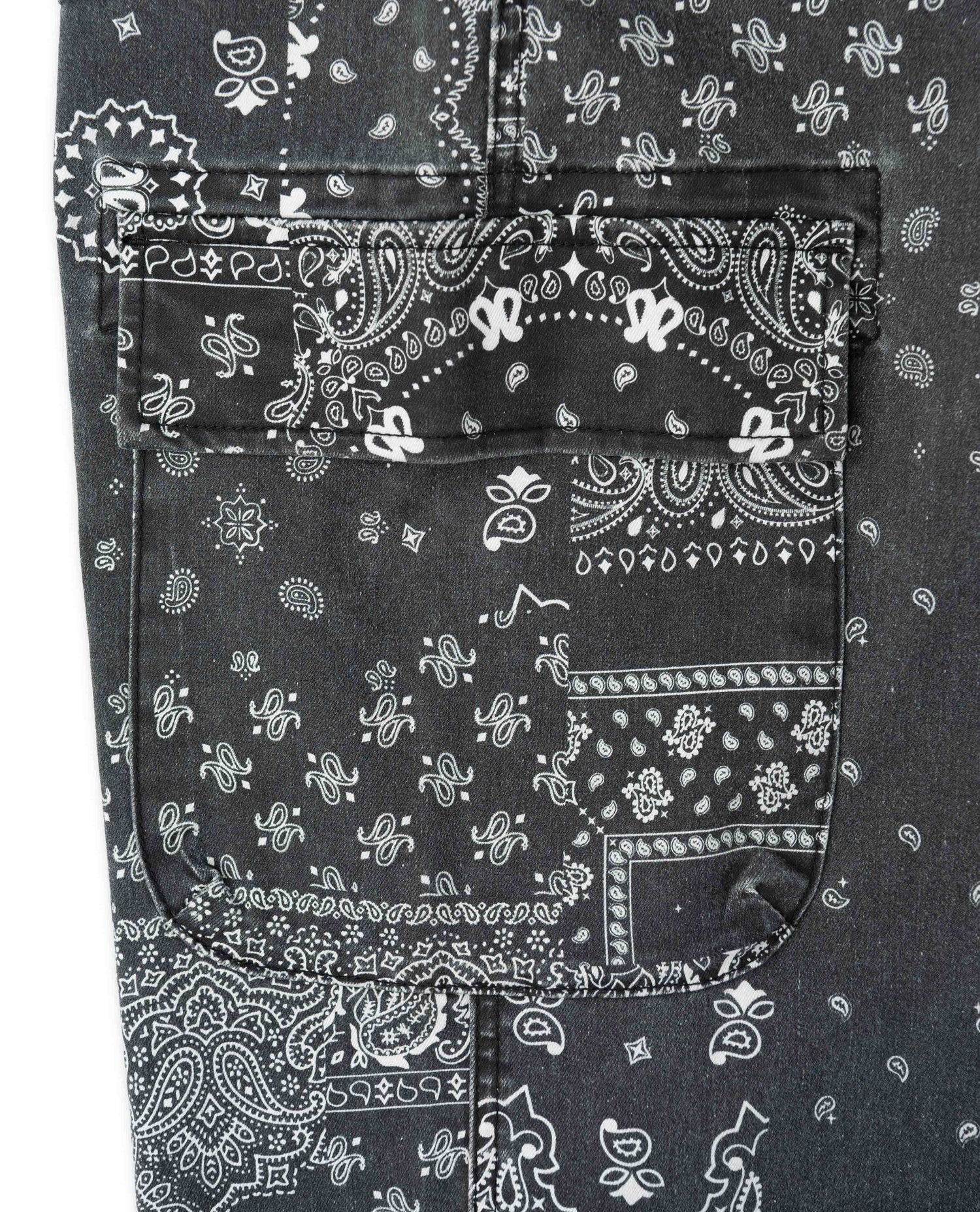 Close up photo of pocket and black and white pants with paisley bandana pattern on white background