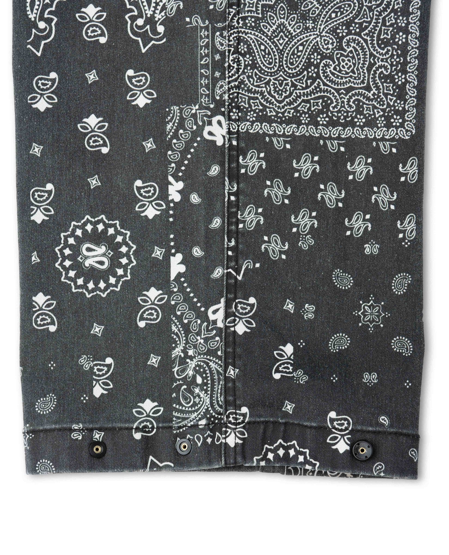 Close up photo of black and white pants with paisley bandana pattern on white background