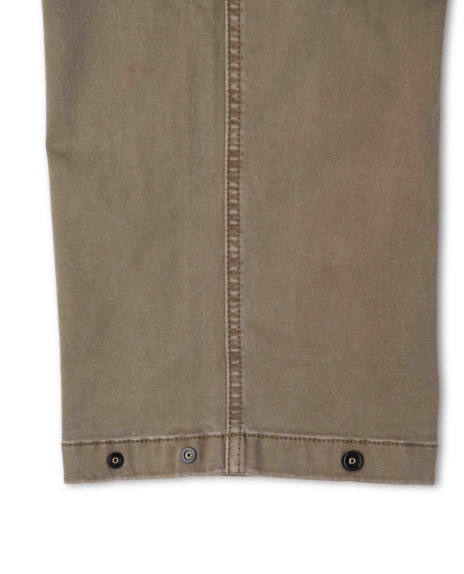 Close up of brown pant with snap detail on white background