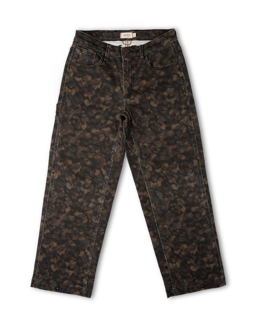 A pair of dark brown and black acid-wash jeans with a mottled, distressed pattern, laid flat against a white background.
