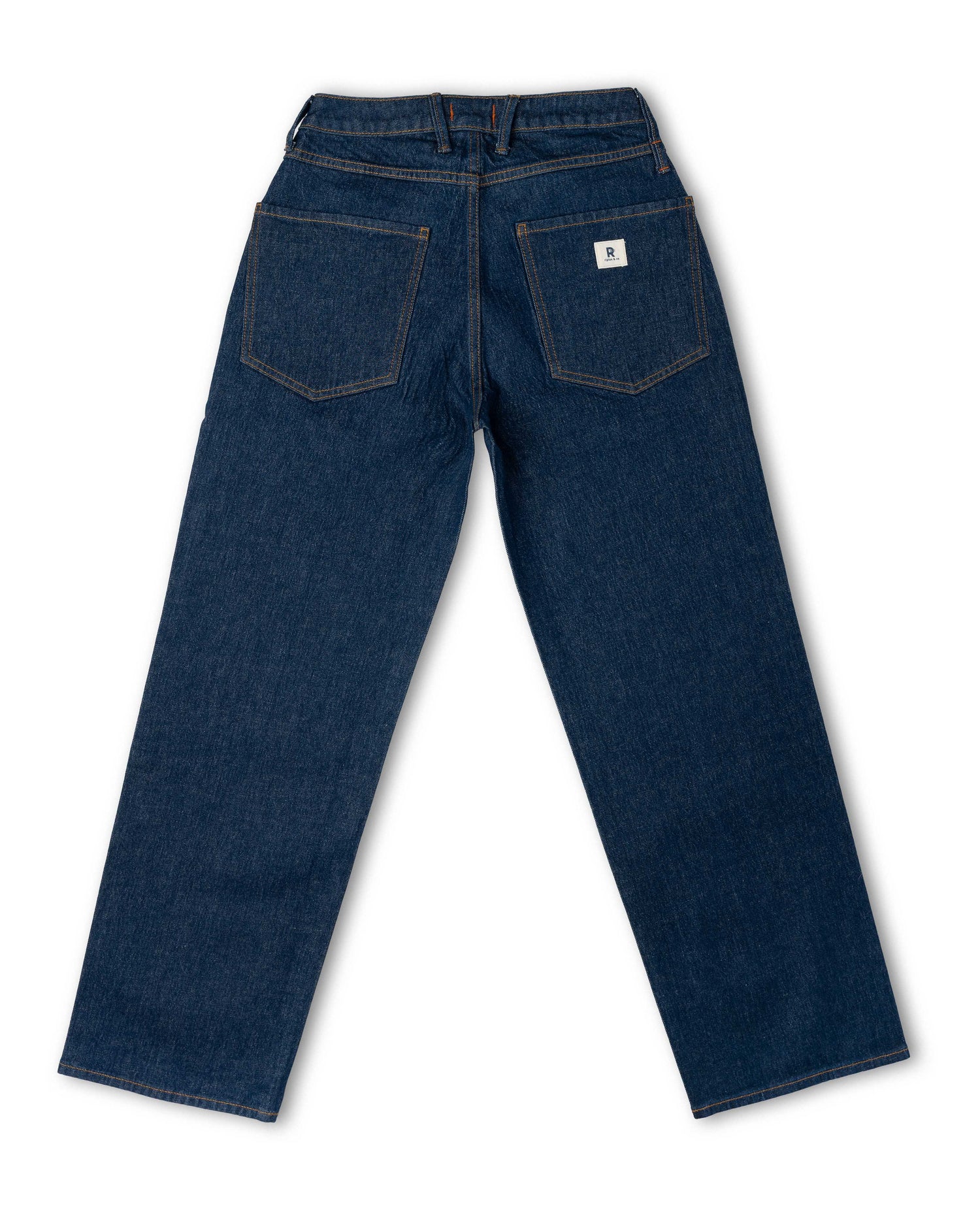 Back view of dark blue denim jeans with a straight leg, featuring classic five-pocket styling and a small white brand patch on the right back pocket.