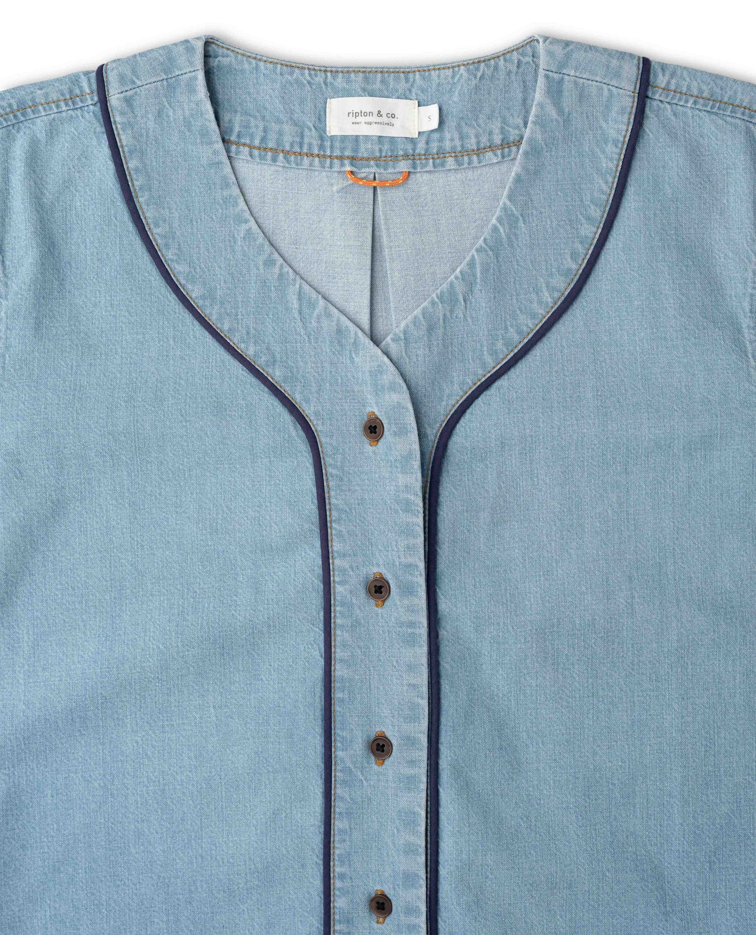 Close up of blue shirt with navy details