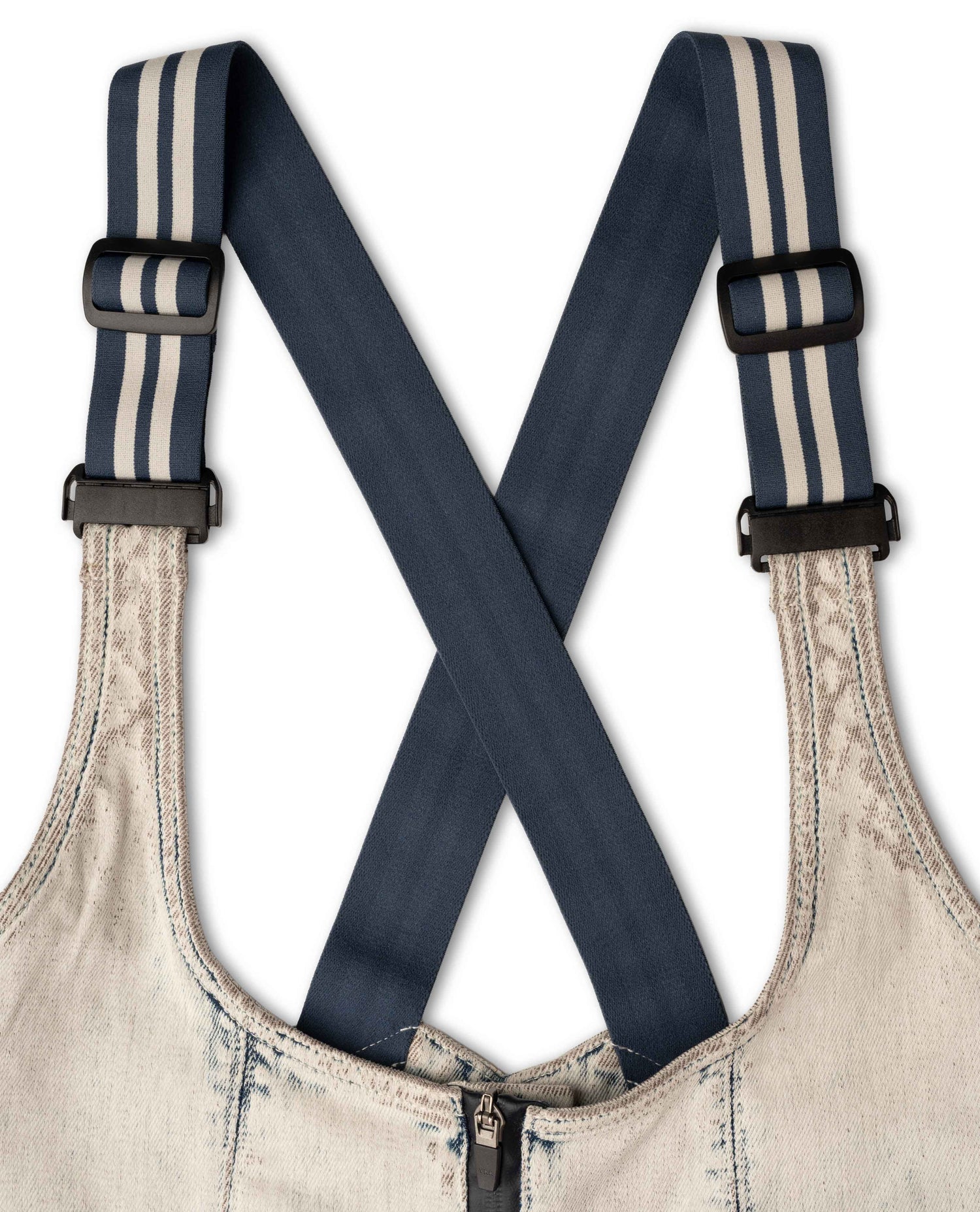 Denim overalls with striped suspenders on a white background