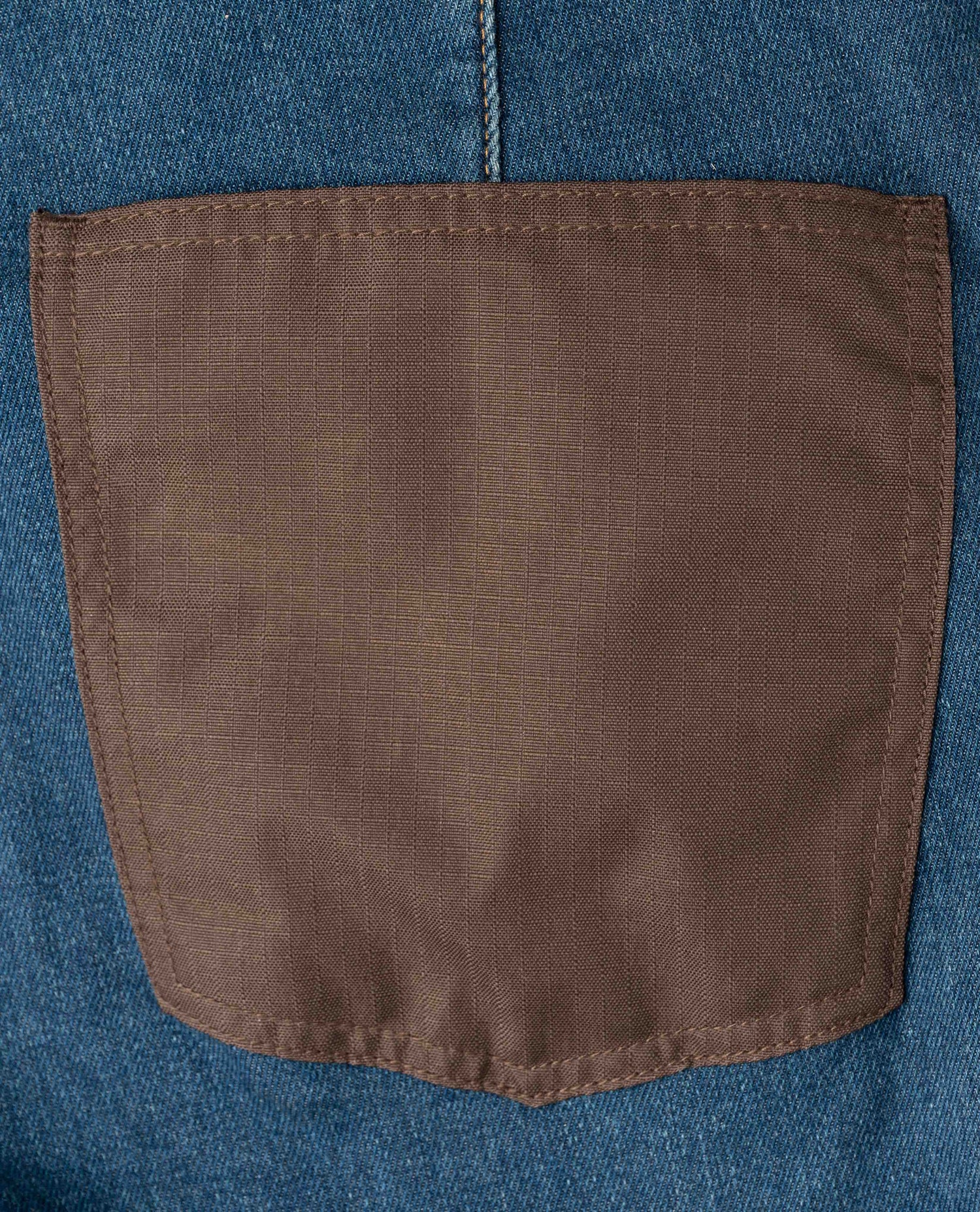 Brown pocket on a blue denim background
