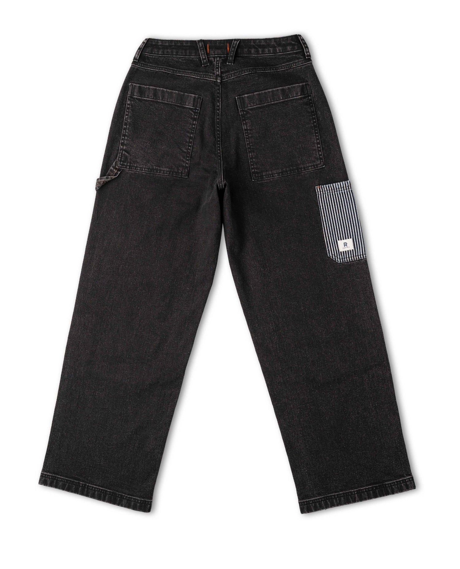 Black jeans with a patch on the back pocket on a white background