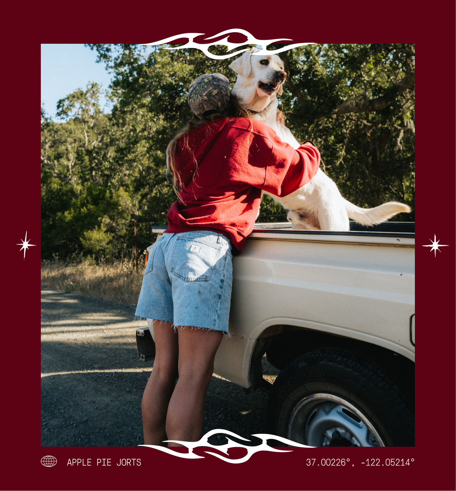 A lifestyle photo of a person in a red hoodie and denim shorts hugging a yellow Labrador retriever sitting in the bed of a cream pickup truck, framed by a dark red graphic border with white flame and star details.