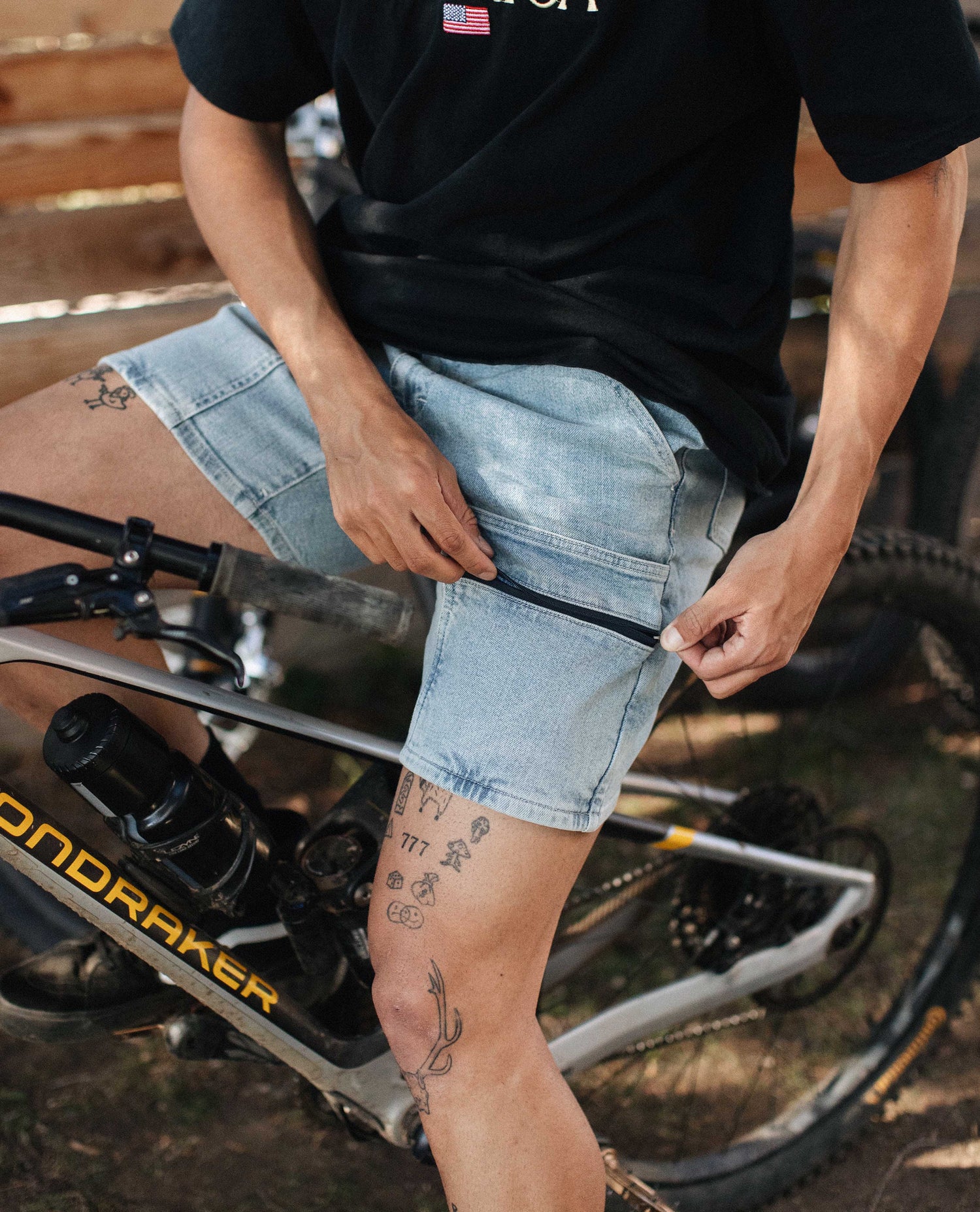 Guy with tattoos wearing Denim Chore shorts