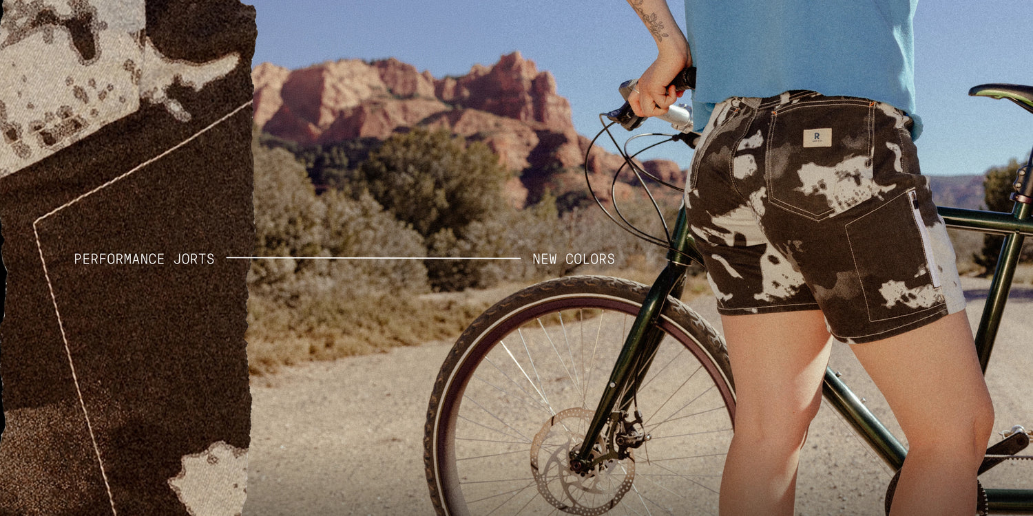 Person wearing camouflage shorts with a scenic background of red rock formations.