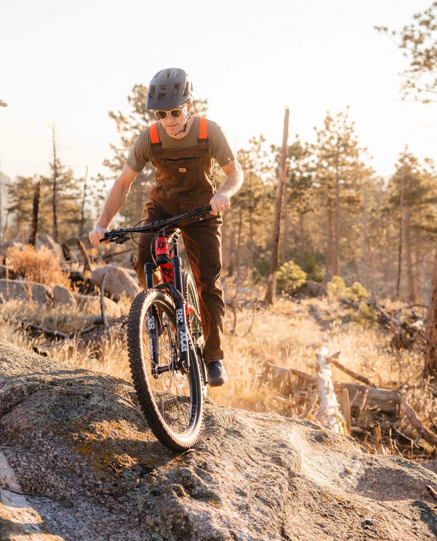 Mountain biker in rust overalls