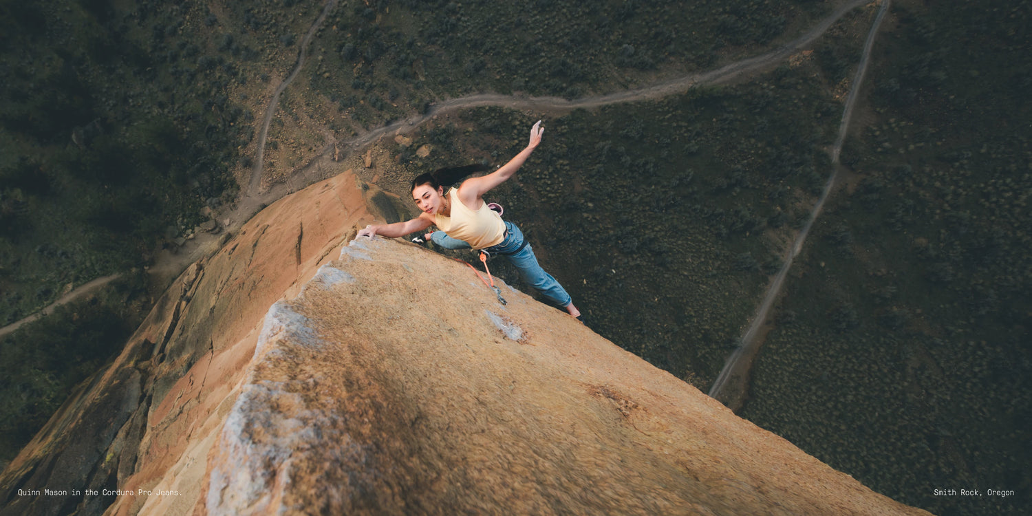 Person standing on a cliff edge with a scenic background