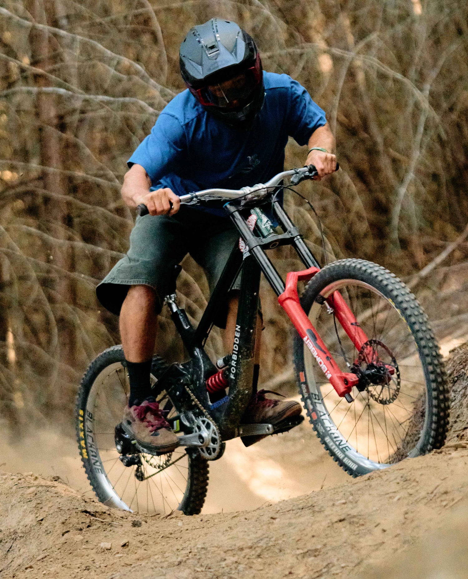 Person riding a mountain bike on a dirt trail with a blurred background
