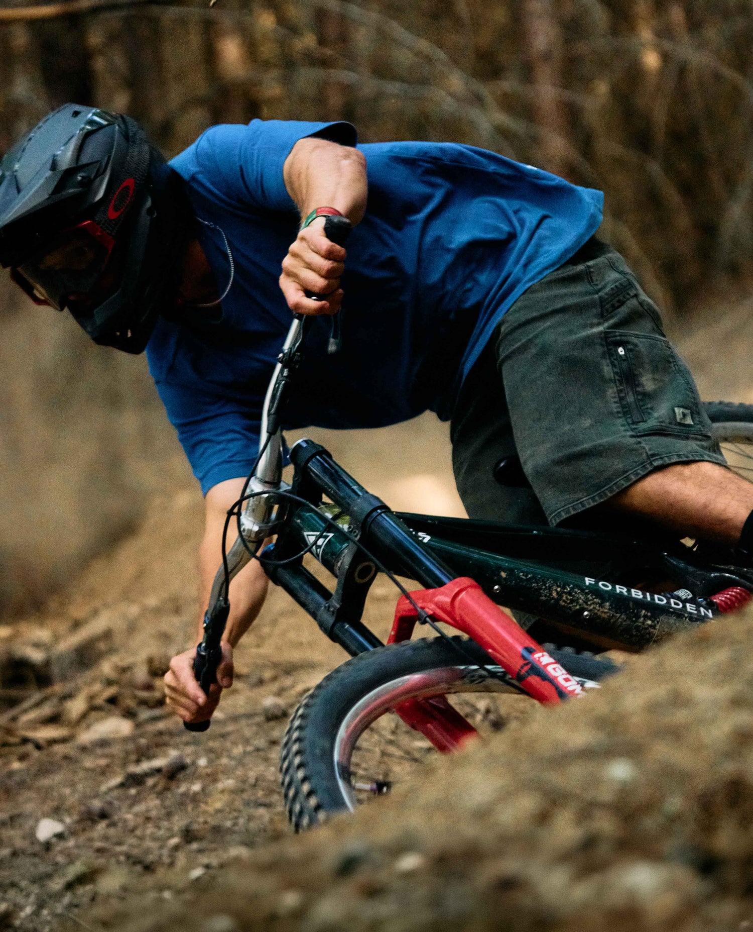 Person riding a mountain bike on a trail with a blurred background
