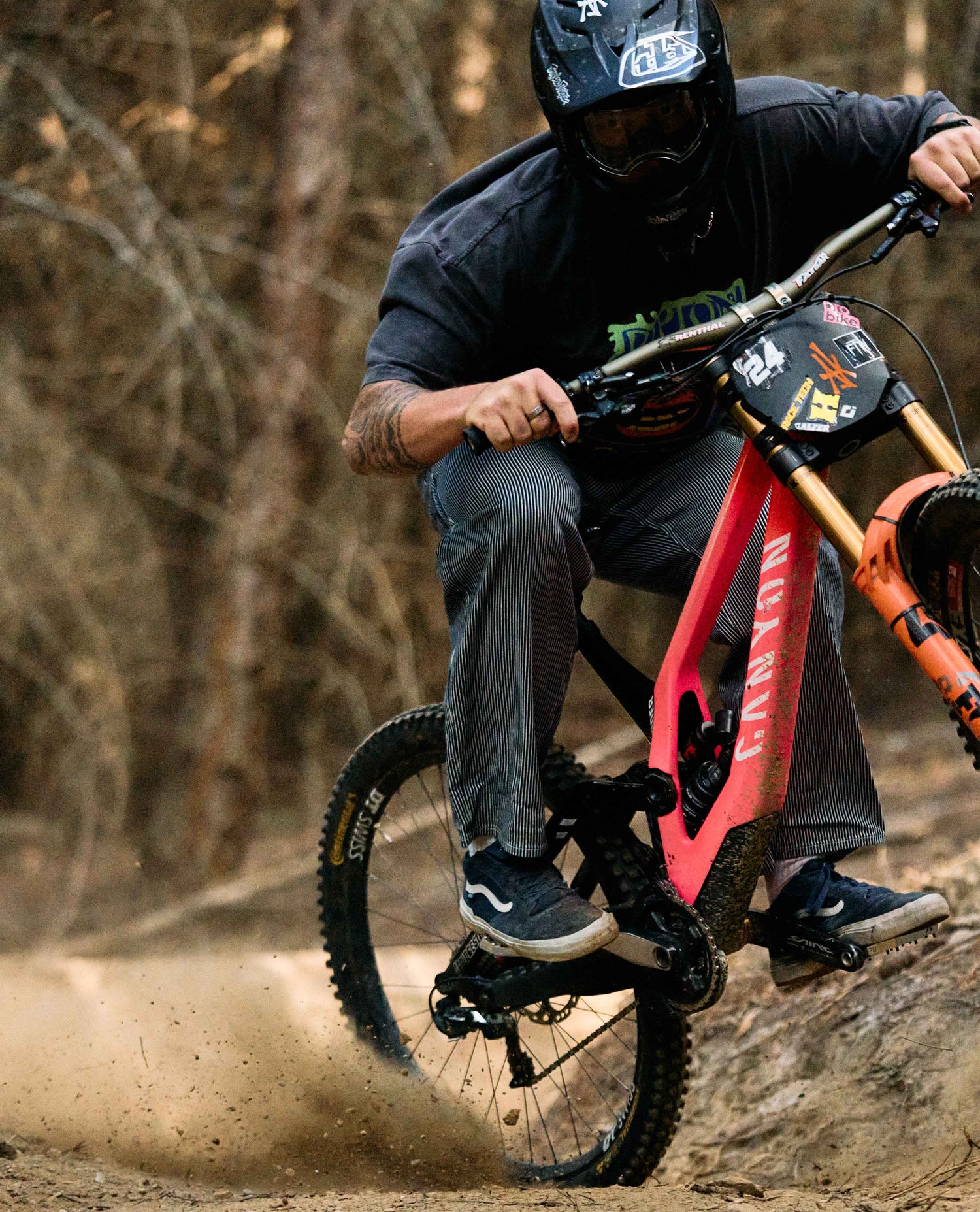 Person riding a mountain bike on a trail with a blurred background