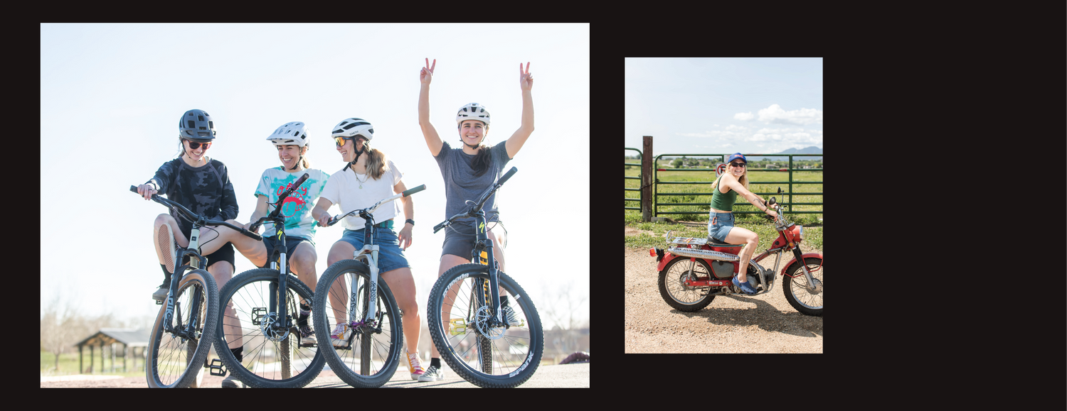 A group of girls in denim shorts and t-shirts posing with their mountain bikes.