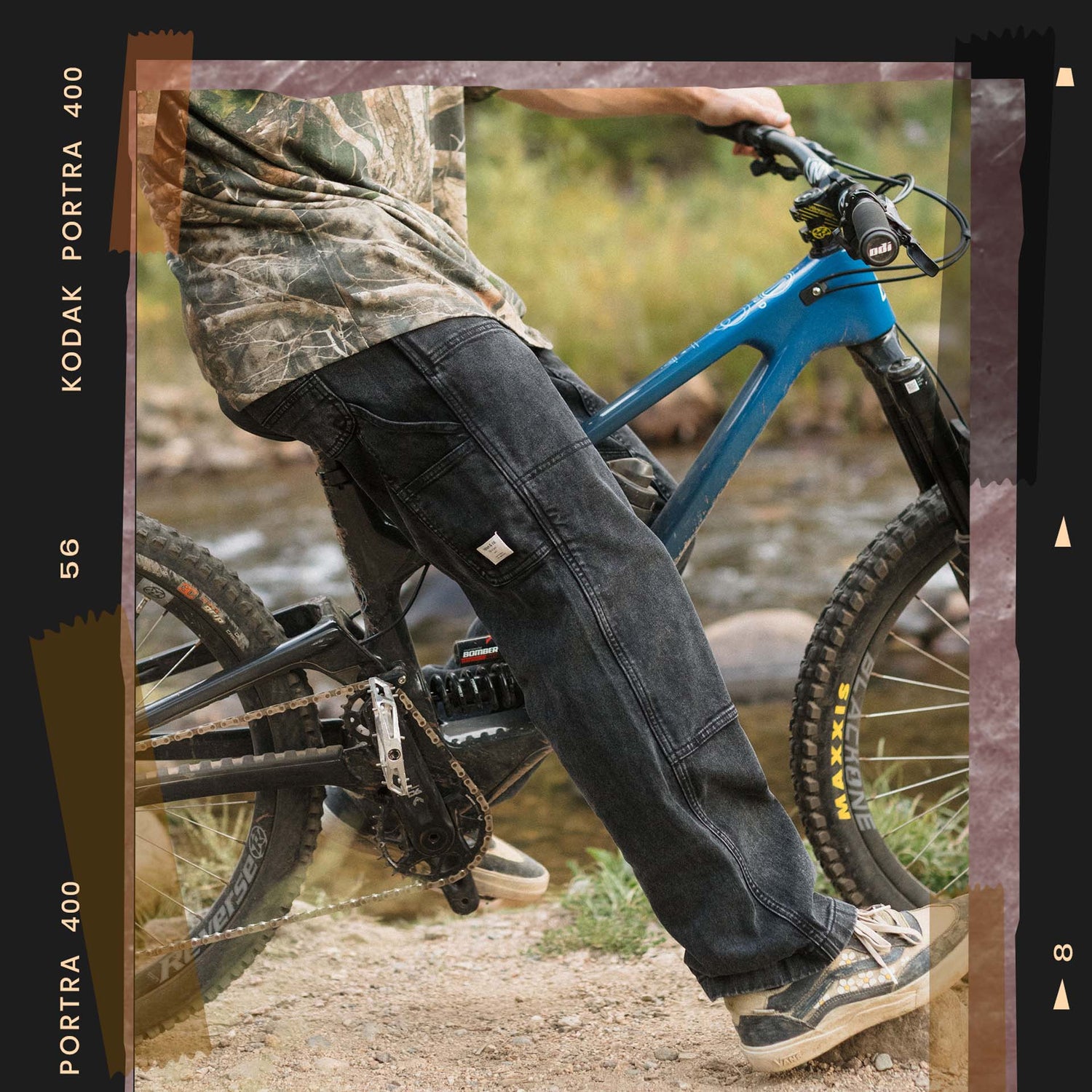 Person riding a blue mountain bike on a trail with a Kodak Portra 400 film strip overlay.